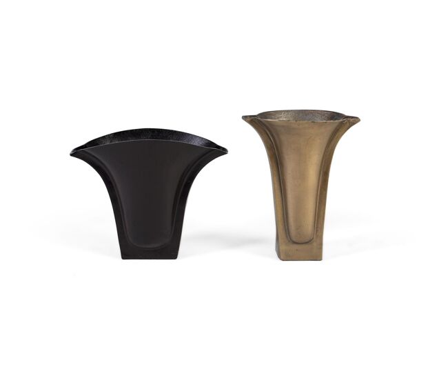 Este set de dos floreros de aluminio destaca por su acabado rugoso en tonos de bronce y latón, que les confiere un carácter artesanal y elegante.